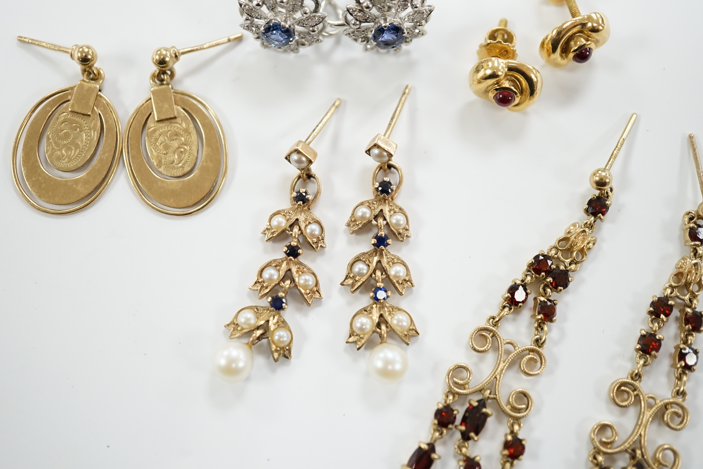 Three pairs of assorted 9ct gold earrings including two gem set, a pair of white metal (stamped 18) and gem set ear clips and a pair of 18k and cabochon ruby ear studs.